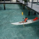 Jessica on Kayak rowing toward Bungalow